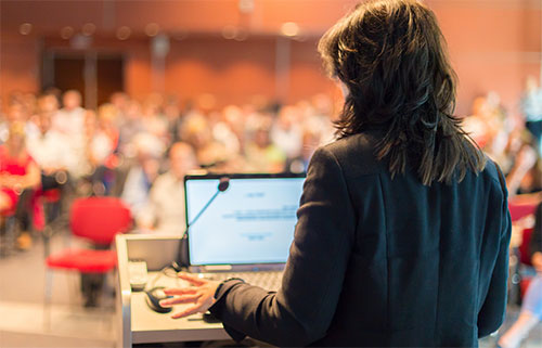 Science communications image of a woman speaking at a conference